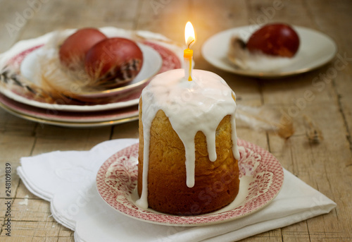 Easter composition with Easter cake and Easter eggs on a wooden background. Rustic style. photo