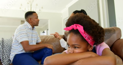 Irritated black children ignoring their parents arguing in living room at home 4k