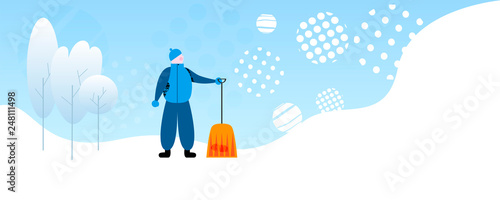 Worker with shovel near trees on winter day