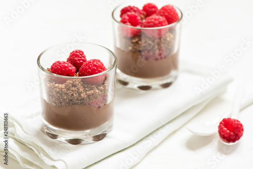Chocolate dessert in glasses with raspberries