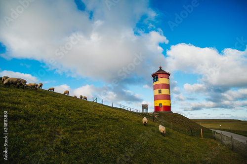 Pilsum Lighthouse on the North Sea in Germany. The red and yellow Lighthouse. 