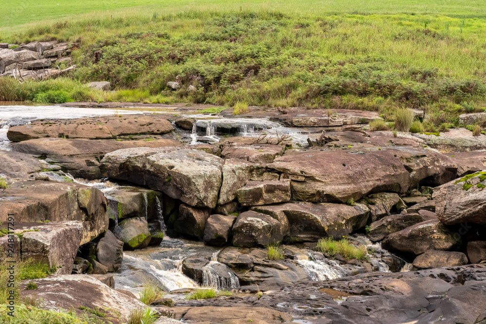 A river flowing over rocks. A river flowing over rocks.