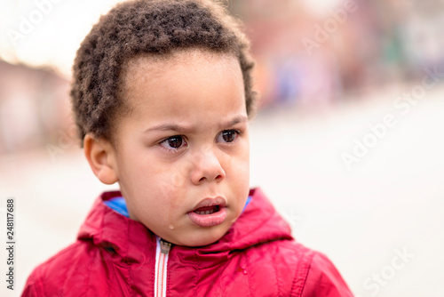 Portrait of a little upset toddler boy crying. 