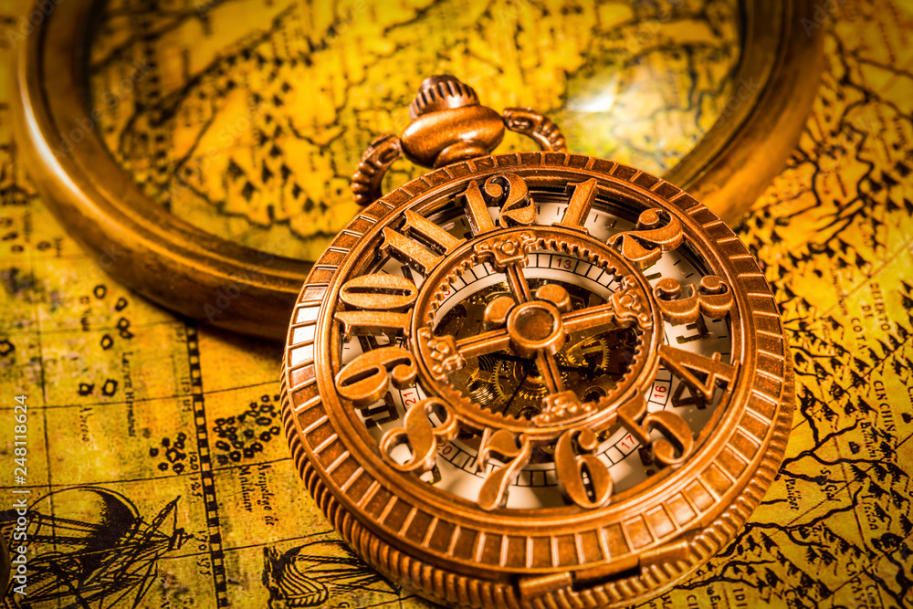 Vintage magnifying glass and pocket watch. Map of the Ancient World in 1565.
