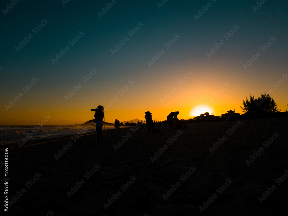 silhouette of surf photographers at sunset in Brazil