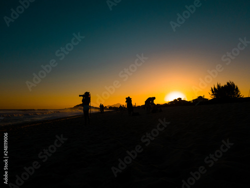 silhouette of surf photographers at sunset in Brazil