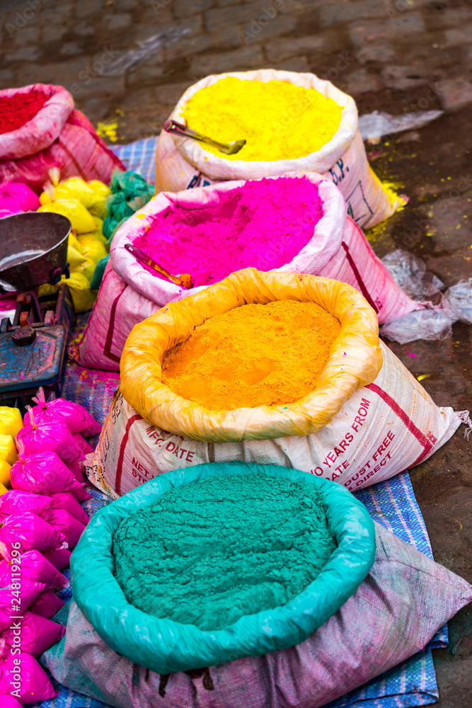 Bags of colored powdered paint sit waiting to be sold to Holi Festival