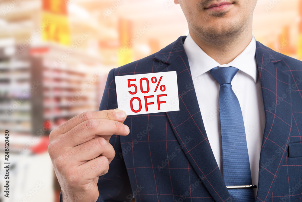 Man presenting card with fifty per-cent off concept. Man presenting card with fifty per-cent off concept.