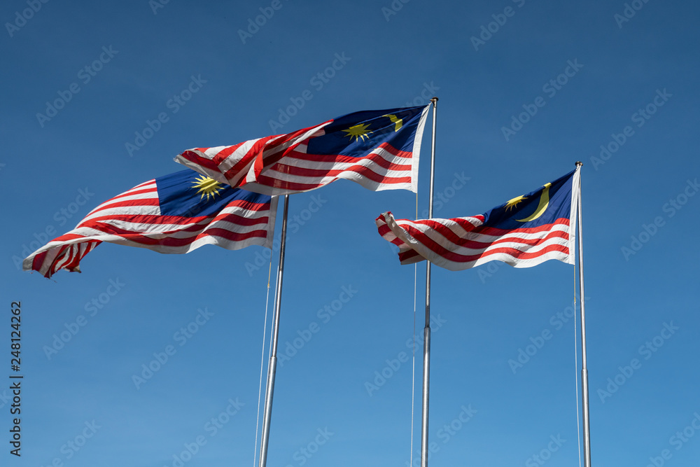 Malaysian flags waving in the sky Malaysian flags waving in the sky