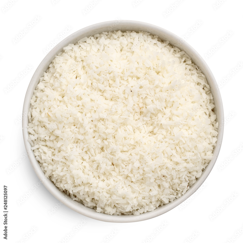 Coconut flakes in a bowl isolated on white background. Top view Coconut flakes in a bowl isolated on white background. Top view