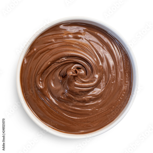 Chocolate hazelnut cream in white bowl, isolated on white. Top view