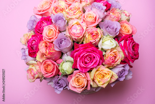 Beautiful bouquet of roses in a gift box. Bouquet of pink roses. Pink roses close-up. on pink background  with space for text.