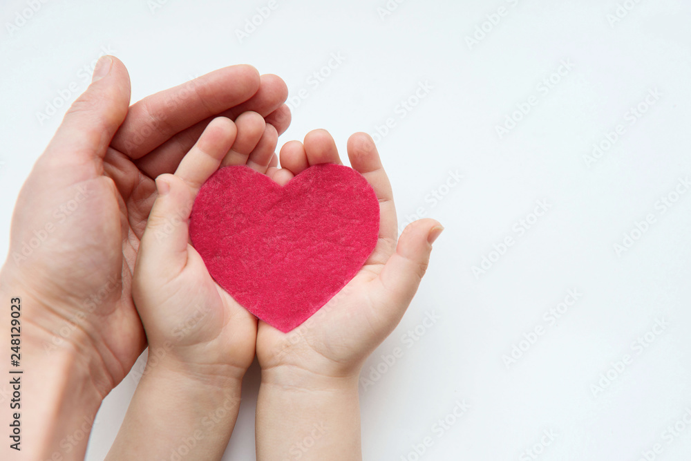 Adult and child hands holding red heart. Health care, donate and family insurance concept, world heart day, world health day, family love concept. Adult and child hands holding red heart. Health care, donate and family insurance concept, world heart day, world health day, family love concept.
