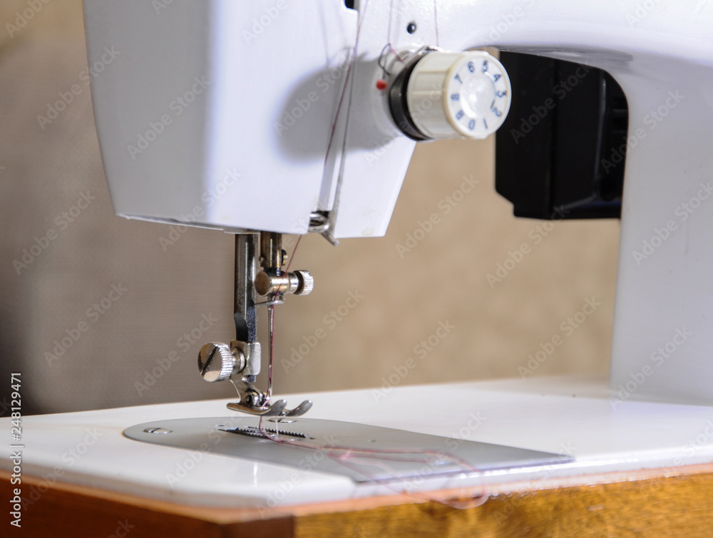 Sewing machine with needle and thread, closeup