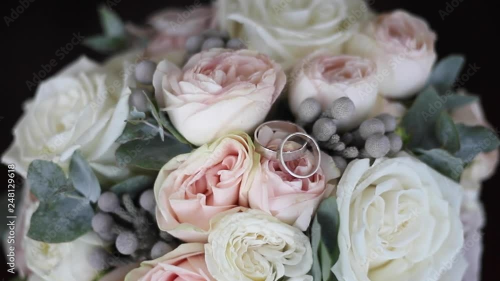White gold rings on the wedding bouquet. Rings on the flowers White gold rings on the wedding bouquet. Rings on the flowers