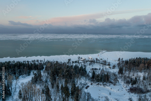 Aerial view of a beautiful sunset in the winter forest. 