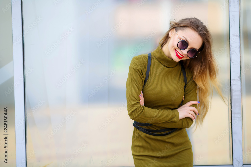 Stylish girl in trendy clothes in the slim dress