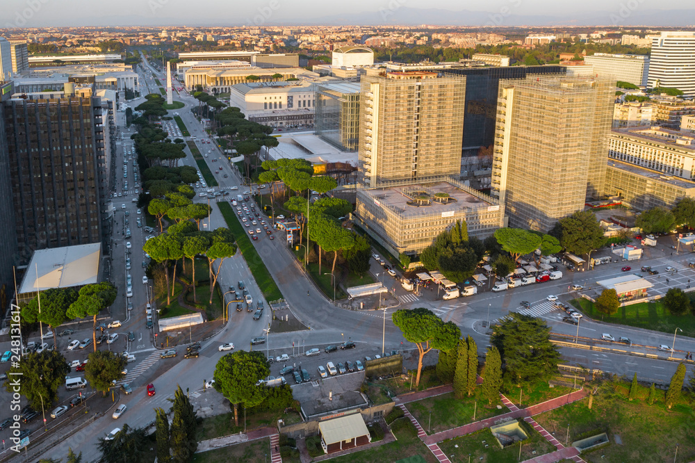 Fototapeta premium Aerial view of the modern EUR district in Rome, built for the Universal Exposition that should have been held in the Capital in 1942. In the foreground the small lake and the neighborhood park