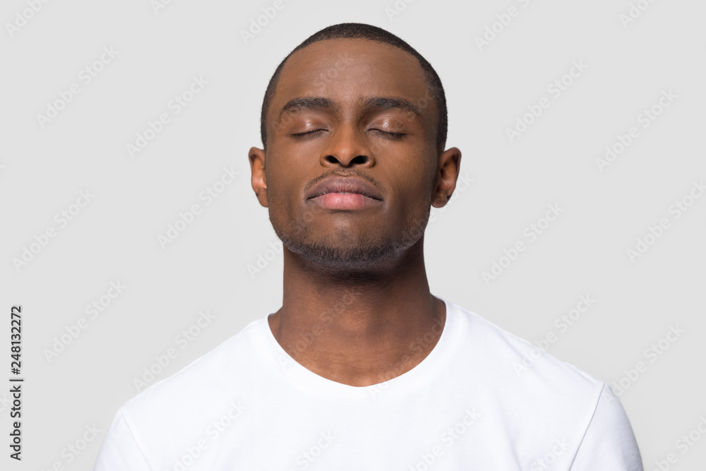 Calm mindful african american man enjoy taking deep breath Calm mindful african american man enjoy taking deep breath
