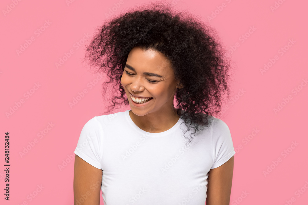 Happy african american girl laughing isolated on pink background Happy african american girl laughing isolated on pink background