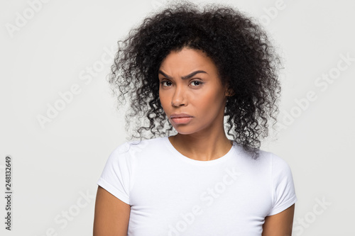 Quadro su tela Suspicious african woman with distrustful face looking at camera