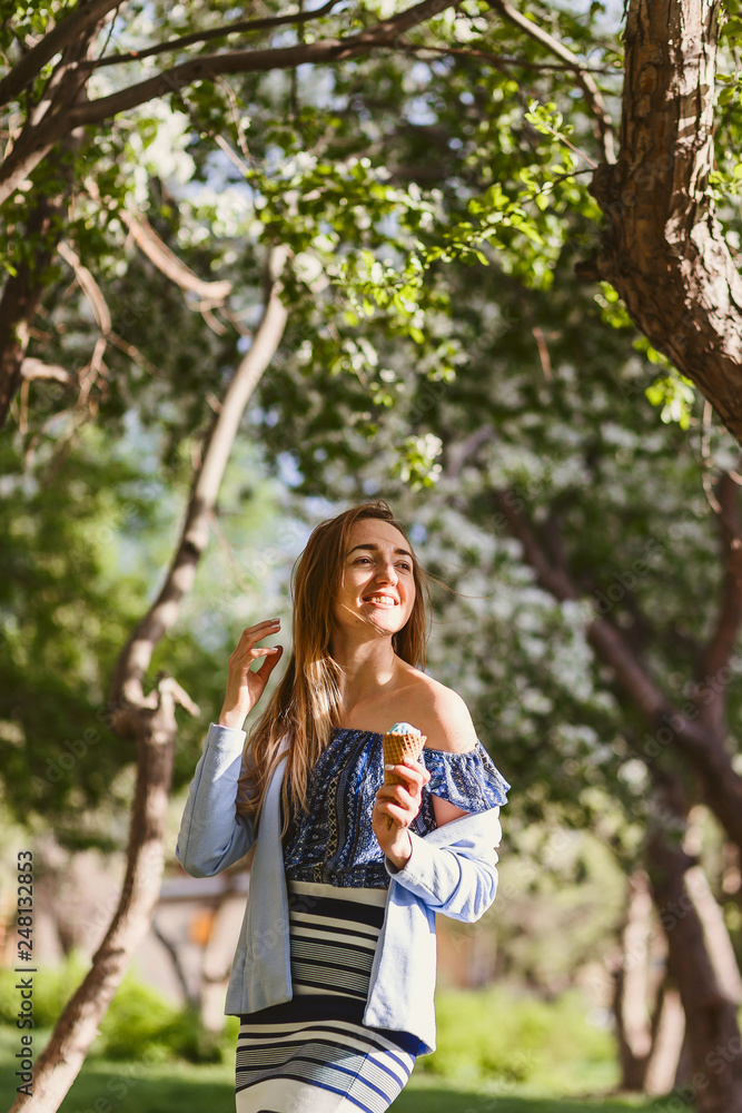 portrait of a young smiling woman with ice cream in her hands in the spring portrait of a young smiling woman with ice cream in her hands in the spring