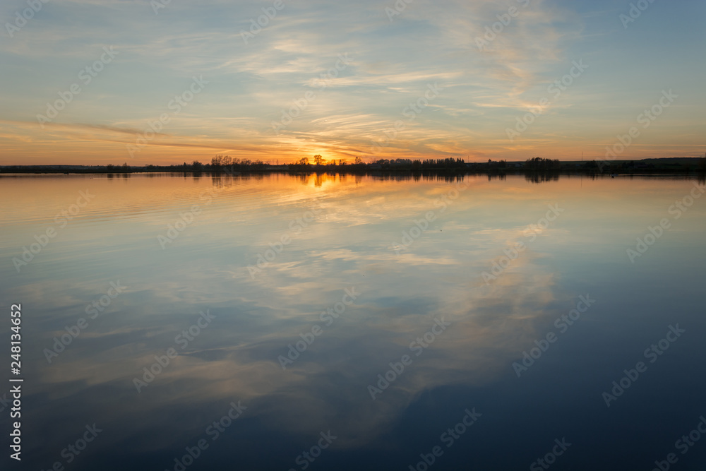Sunset in the sun over a calm lake