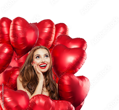 Happy surprised woman with red balloons isolated on white background. Surprised girl with red lips makeup smiling and looking up. Surprise, gifts and Valentine's day concept isolated over white © artmim