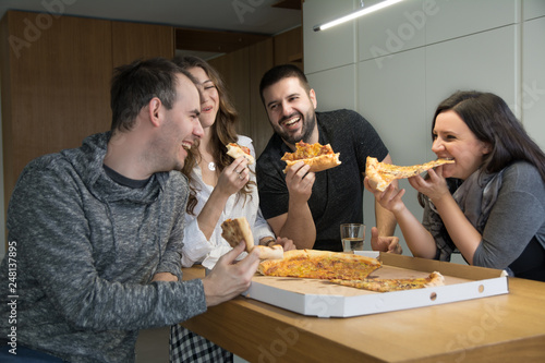 Friends are crazy laughing while enjoying the pizza