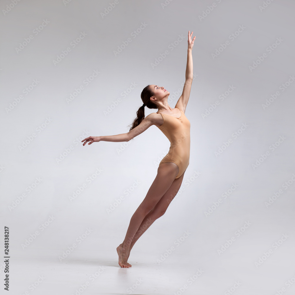 Fototapeta premium young beautiful dancer in beige swimsuit