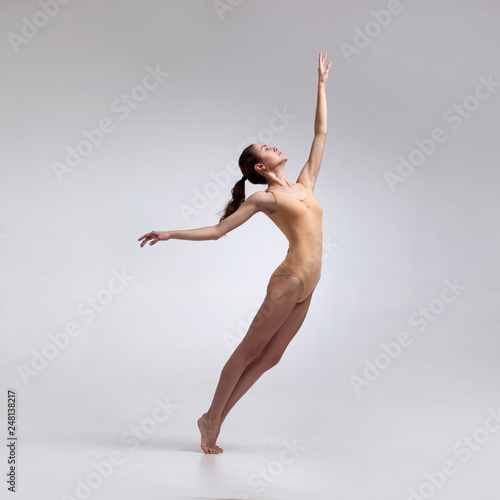 Fototapeta Naklejka Na Ścianę i Meble -  young beautiful dancer in beige swimsuit