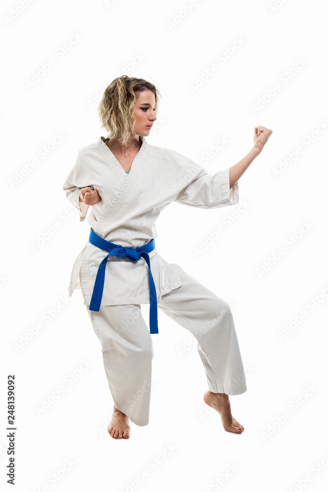 Full body of woman making martial arts pose wearing white outfit Full body of woman making martial arts pose wearing white outfit