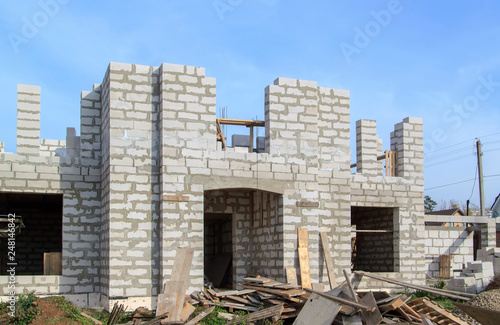 exterior of a country house under construction. Site on which the walls are built of gas concrete blocks and ladder