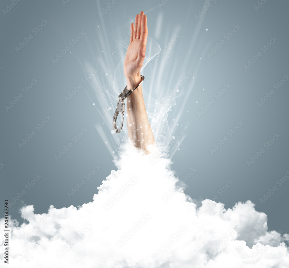 Naklejka premium Hand breaking out from cloud
