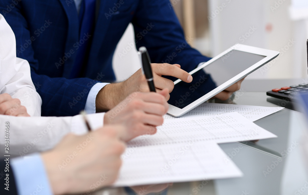 Businessman using laptop at meeting, closeup of hands. Business operations concept Businessman using laptop at meeting, closeup of hands. Business operations concept
