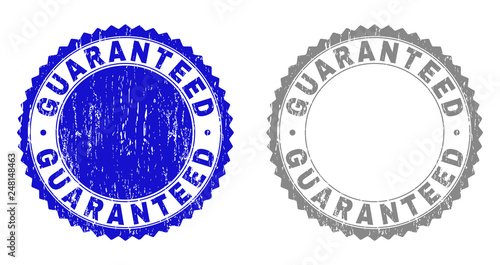 Grunge GUARANTEED stamp seals isolated on a white background. Rosette seals with grunge texture in blue and grey colors. Vector rubber stamp imprint of GUARANTEED label inside round rosette.