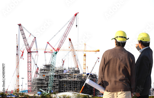 Chemical plant under construction with big crane with engineer working on site