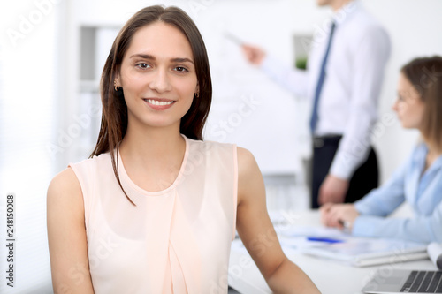 Portrait of a young business woman at meeting. Negotiation concept