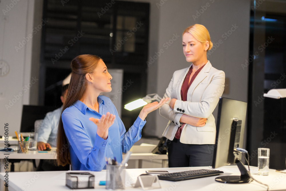 Fototapeta premium business, deadline and technology concept - businesswomen with computer working late at night office