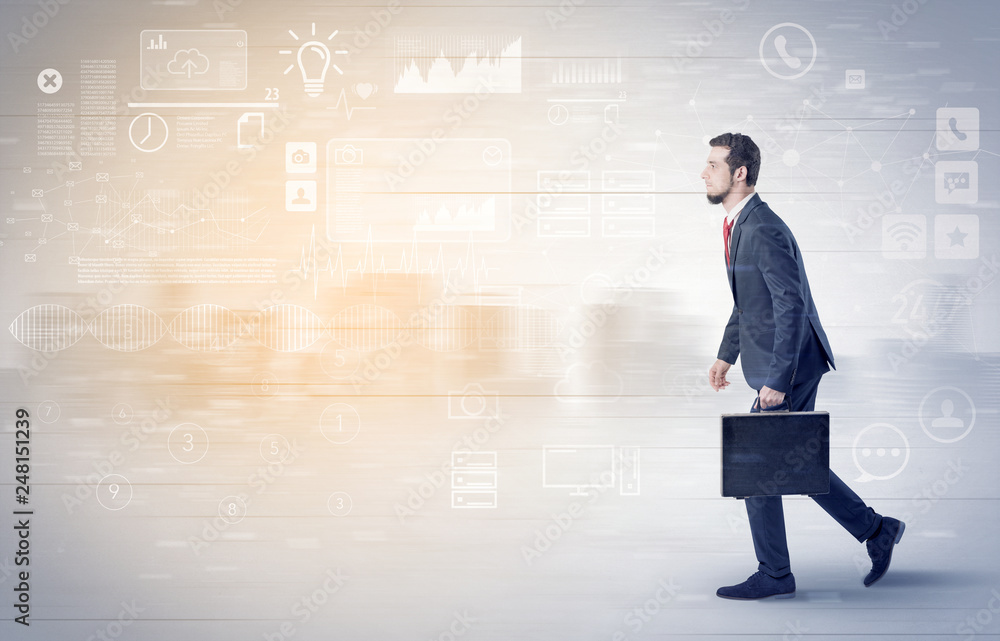 Handsome businessman walking in suit with briefcase on his hand and database concept around
Handsome businessman walking in suit with briefcase on his hand and database concept around