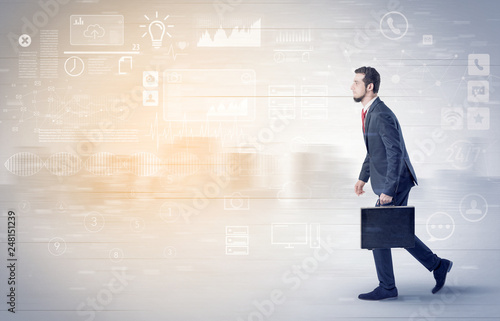 Handsome businessman walking in suit with briefcase on his hand and database concept around  