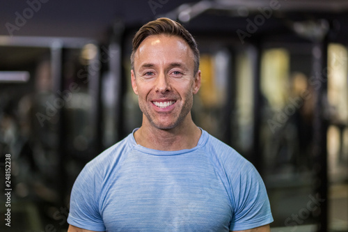 Portrait of fitness man smiling at the gym.