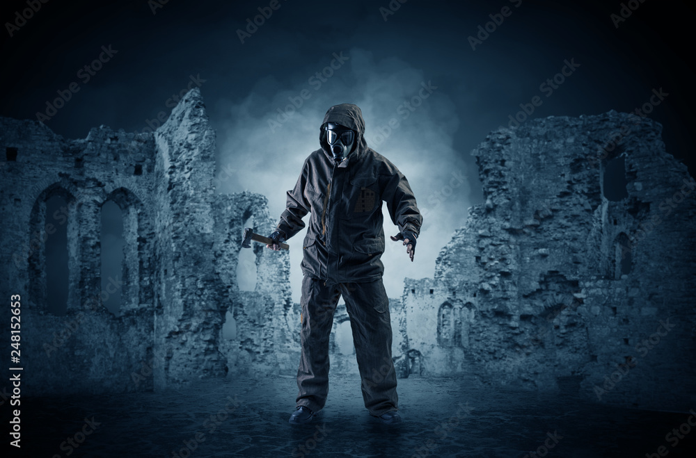 Hazard, menace man in a ruined crumbly building with arms on his hand
