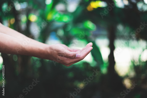Two Hand of Man reaching out receiving rainwater © yupachingping