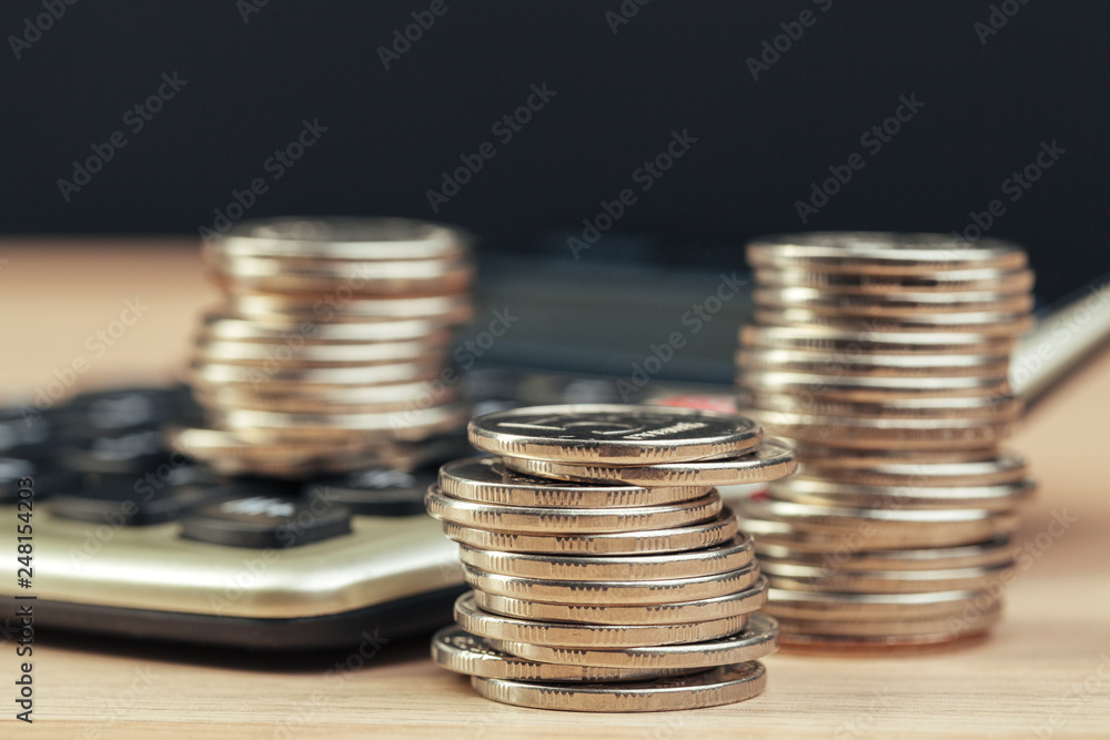 stack of coins and calculator,concept idea for business finance stack of coins and calculator,concept idea for business finance
