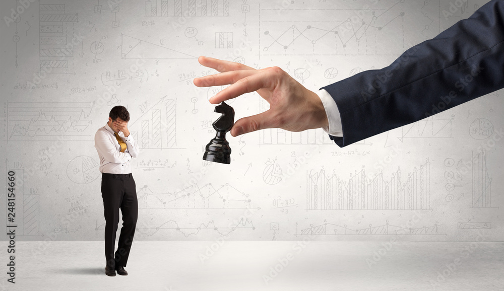 Little businessman is afraid to make the next step in his chess game with graphs, charts and reports background
Little businessman is afraid to make the next step in his chess game with graphs, charts and reports background