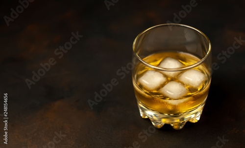 Whiskey with ice on concrete