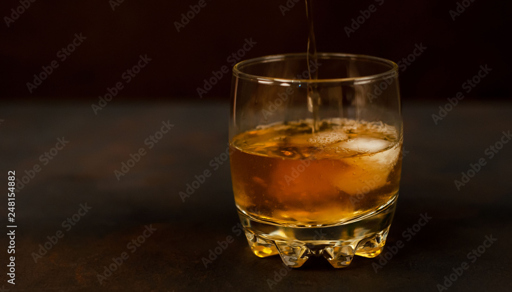 Whiskey with ice on concrete Whiskey with ice on concrete