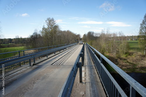 Narrow bridge of metal and wood for crossing the Salaca River in Latvia.