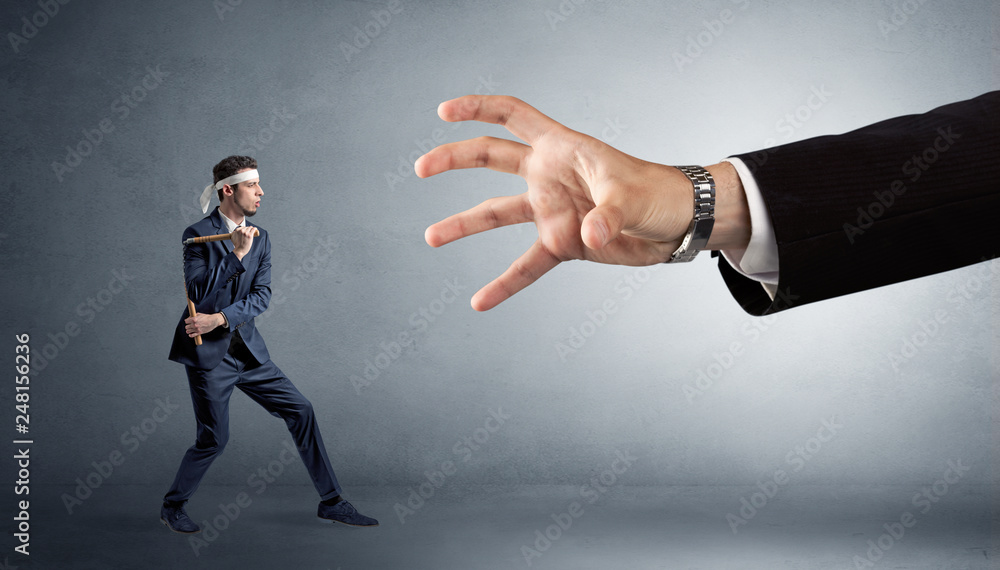 Small karate man fighting with big hand Small karate man fighting with big hand